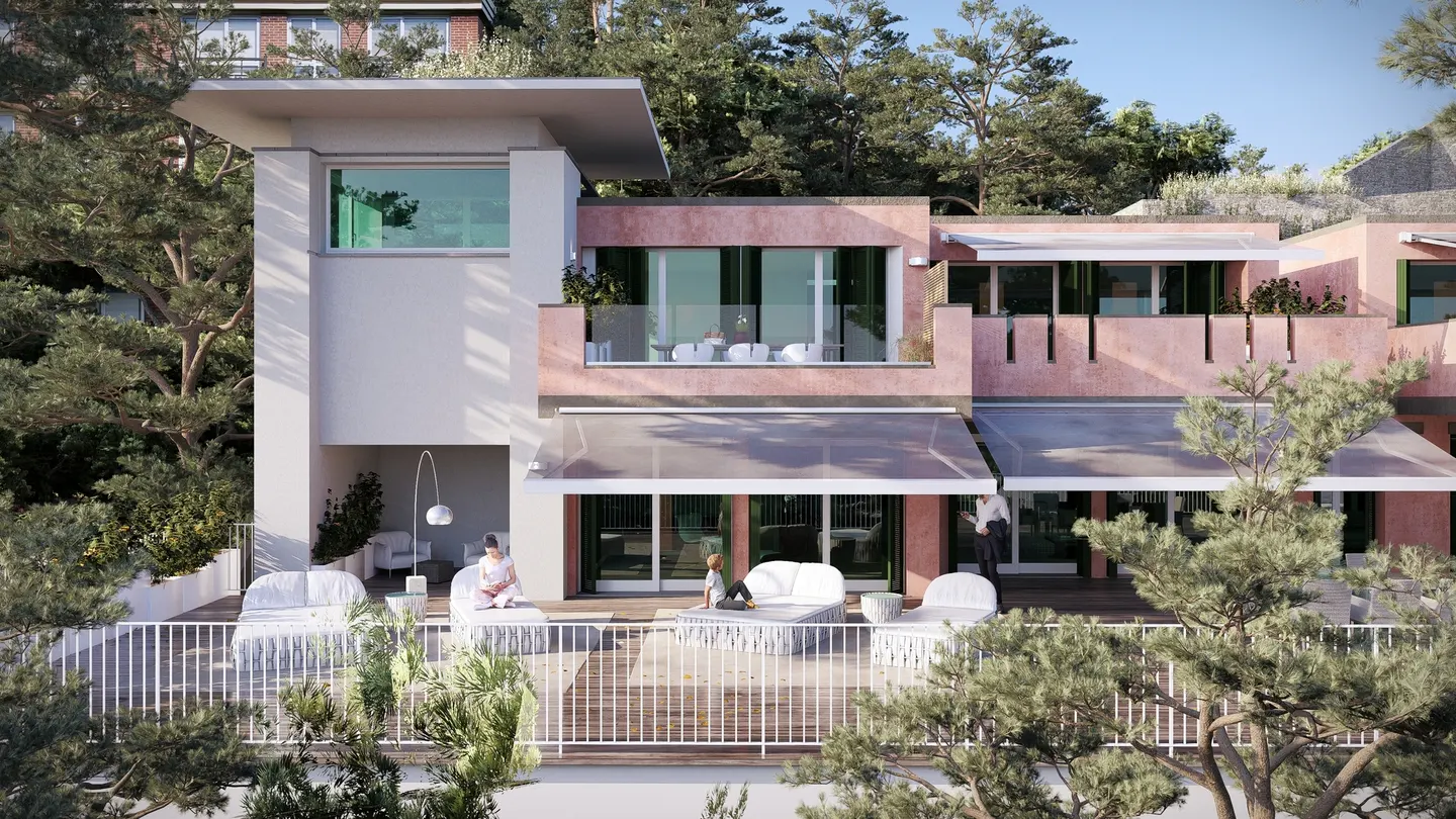 Exterior view of a modern, multi-story home with a white balcony, pink walls, and lush green trees surrounding the property.