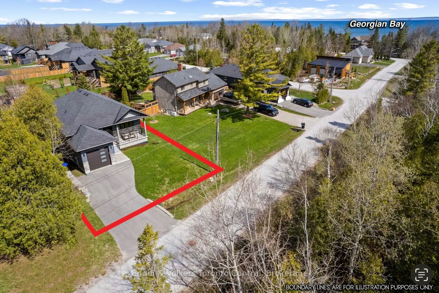 Aerial view of a modern gray house with a red boundary line on a green lawn near Georgian Bay.