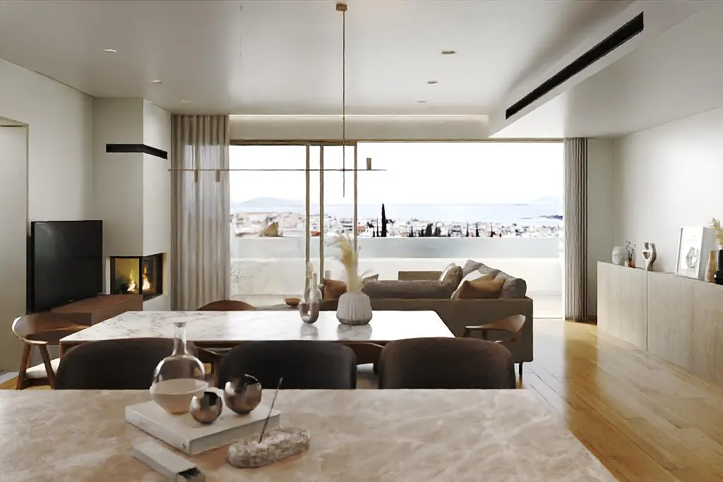 Bright, modern living room with a marble dining table, brown chairs, and a view of the city and sea. A fireplace and TV are visible.