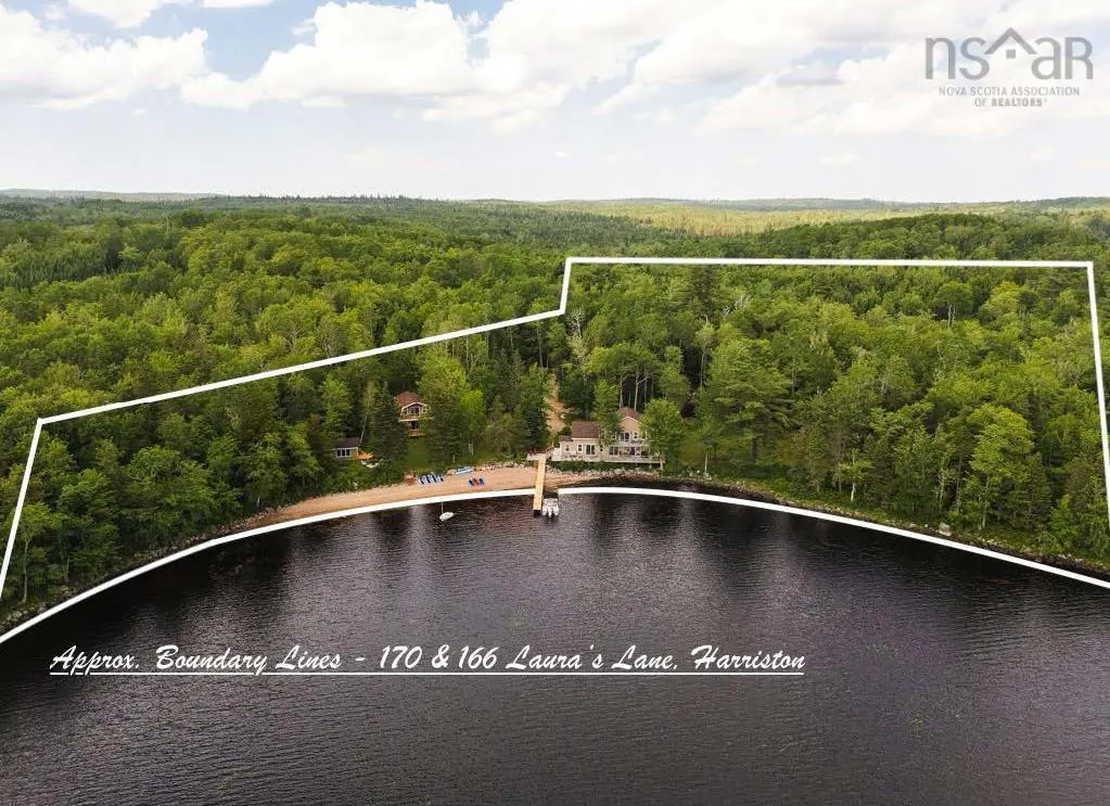 Aerial view of waterfront property with boundary lines, showing a house, beach, dock, and dense green forest.