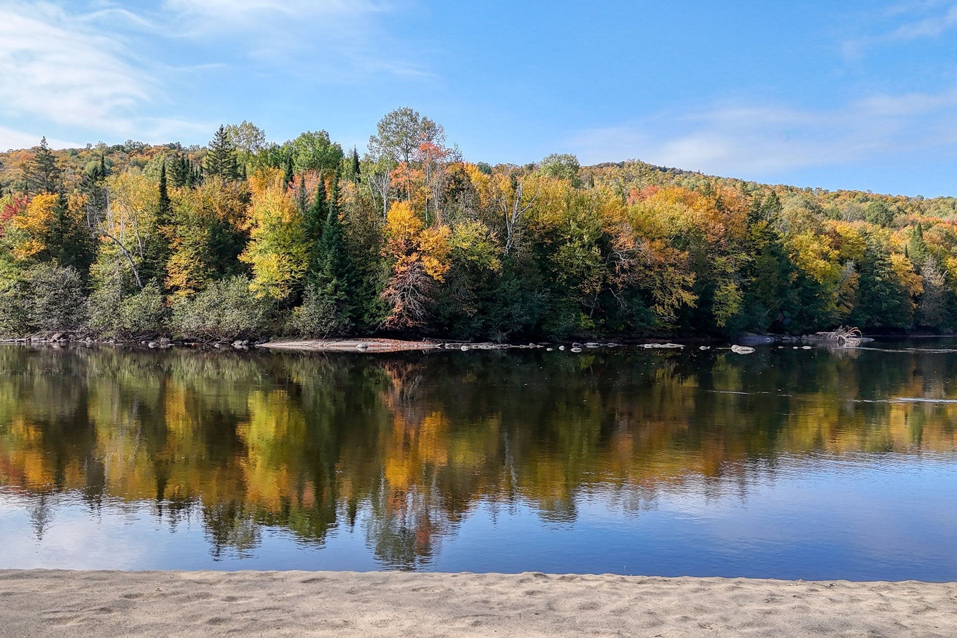 3-Season cottage on the Riviere Rouge with wide sandy beach.