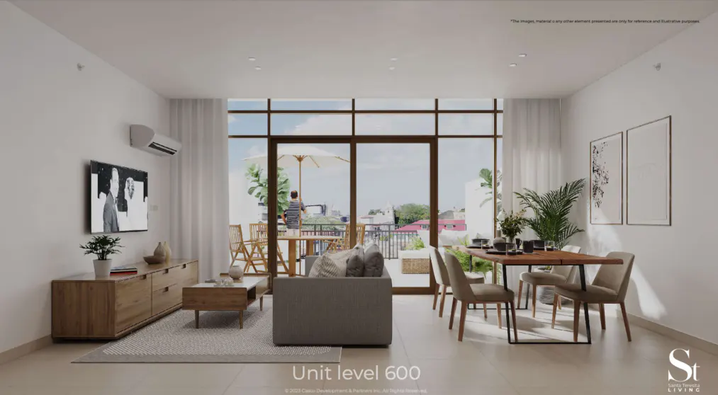 Bright living room with a gray sofa, wood furniture, and a dining table. Large windows open to a balcony with outdoor seating and city views.