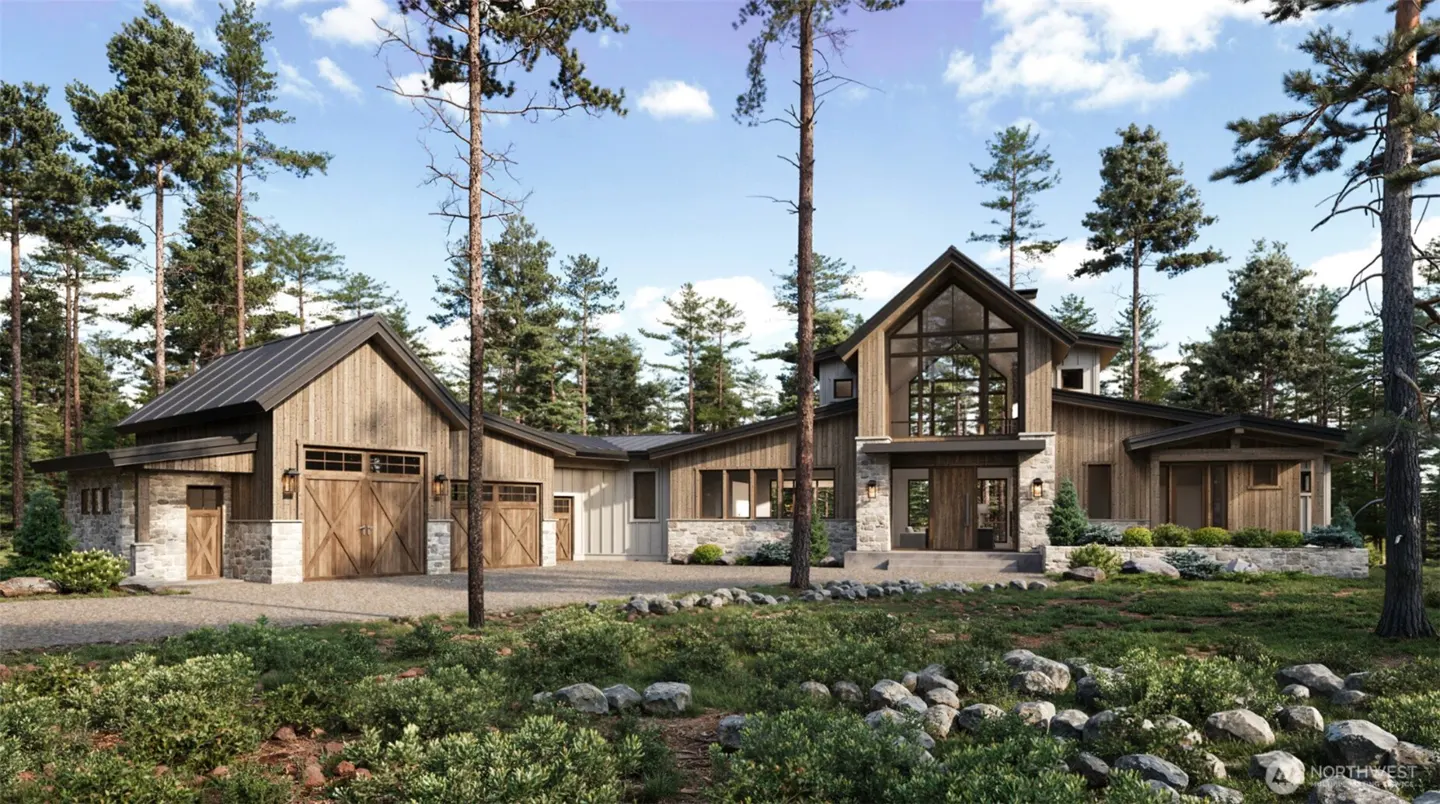 Exterior view of a modern wood and stone house with a garage, surrounded by tall trees and a rocky landscape.