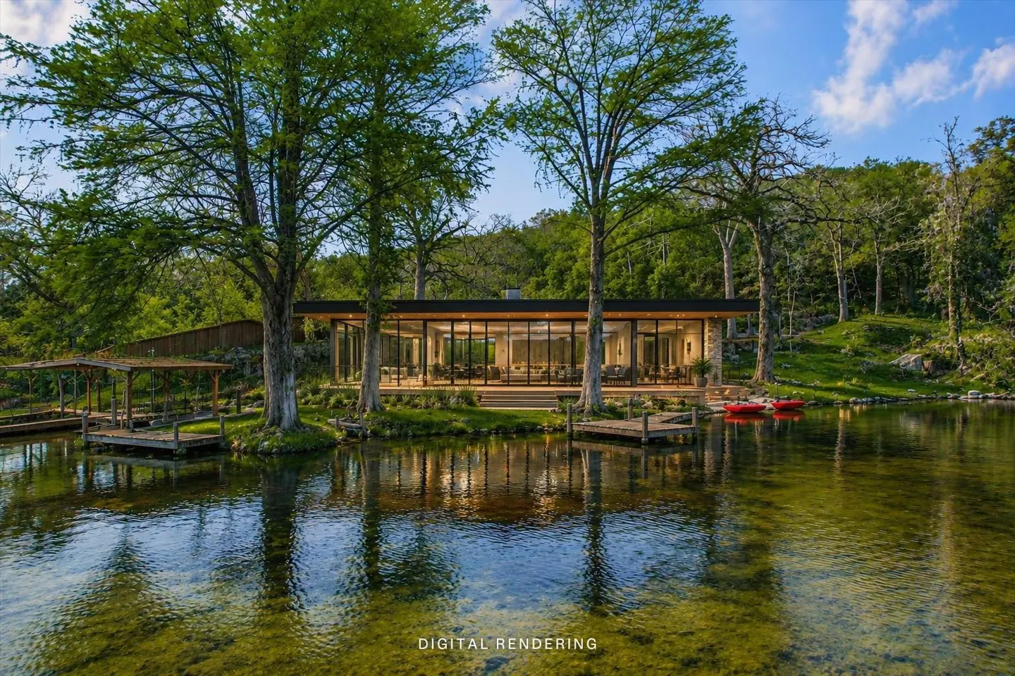 Waterfront home with floor-to-ceiling windows, surrounded by trees and a dock. Two red kayaks sit on the water.
