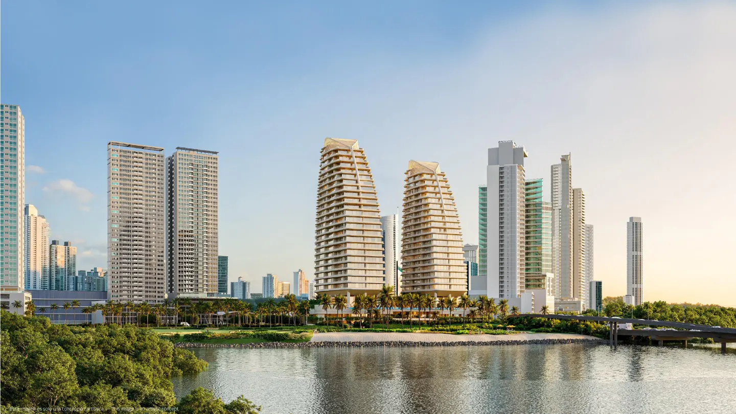 Cityscape view of modern high-rise buildings and skyscrapers along the waterfront. Palm trees and lush greenery line the shore.