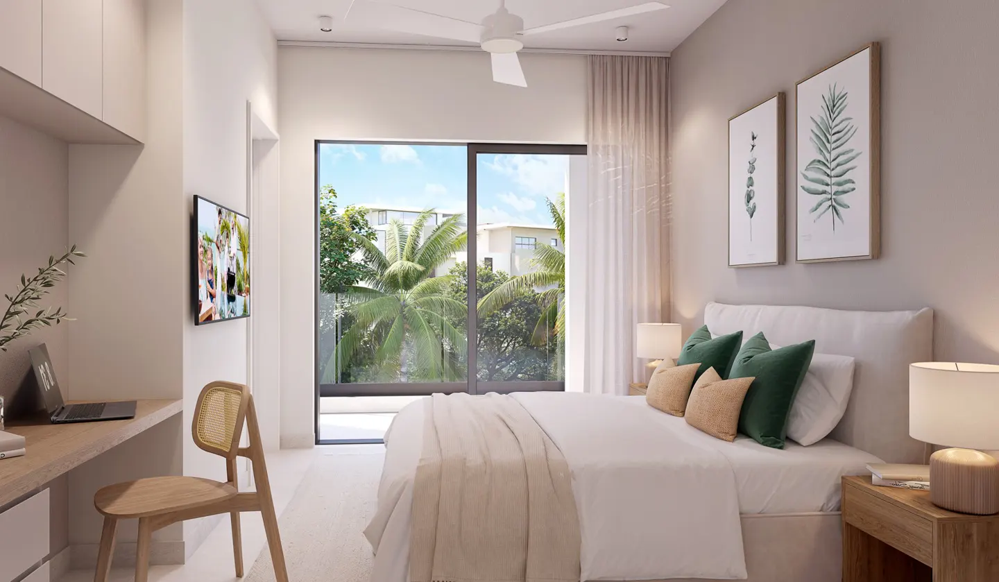 Bright bedroom with a desk, bed, and large window showing palm trees. The walls are light gray, and there are botanical prints on the wall.