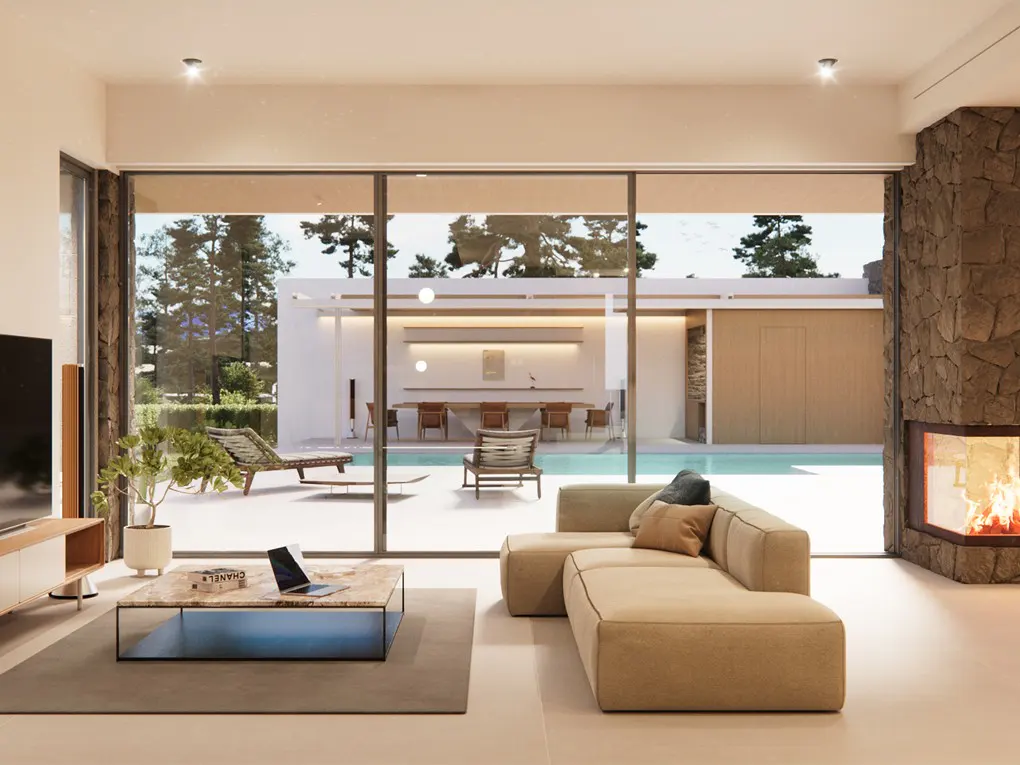 Living room with a beige sofa, marble table, and fireplace. Outside, a pool and dining area are visible through large glass doors.