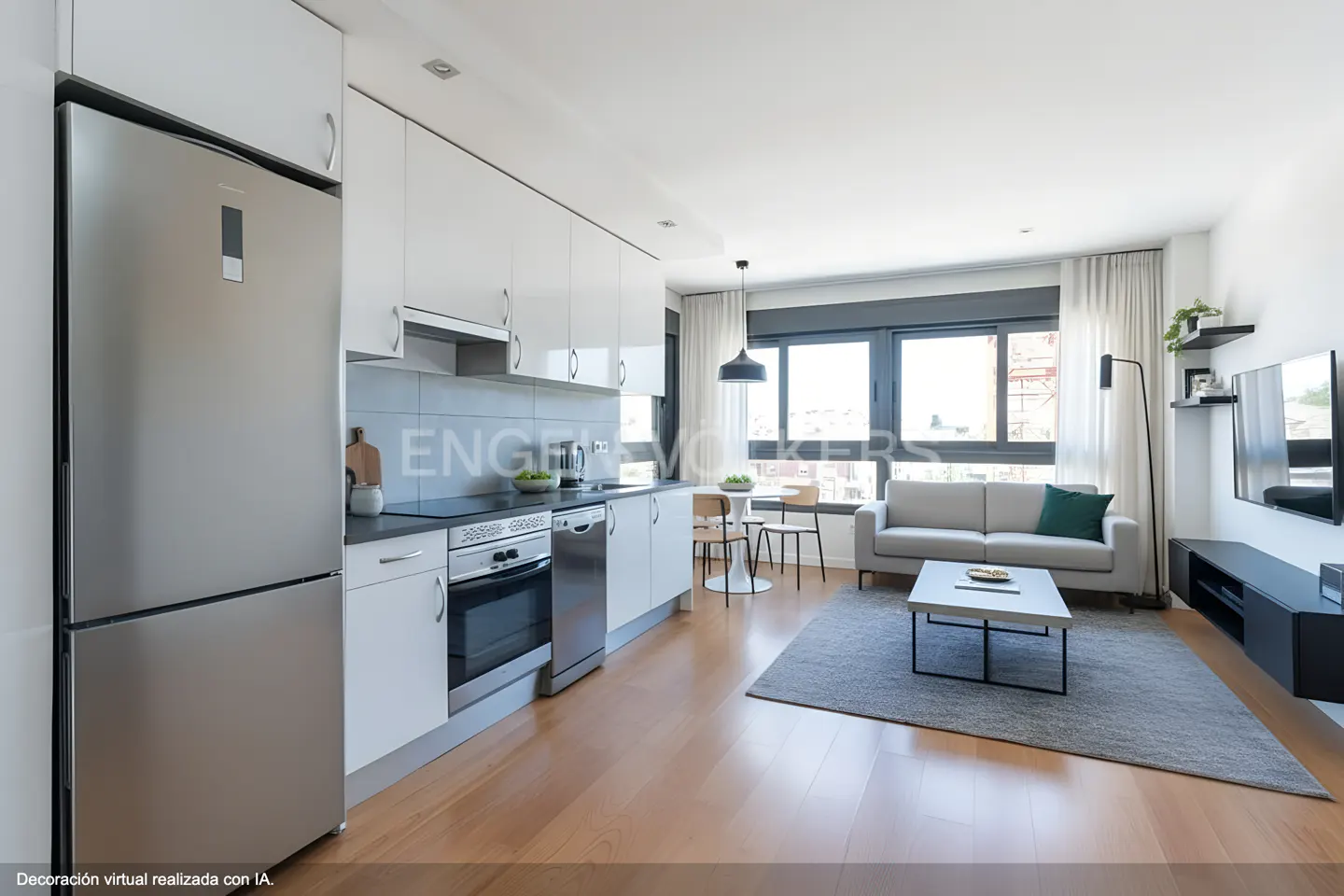 Open-concept apartment with a stainless steel fridge, white cabinets, wood floors, and a gray sofa and rug.