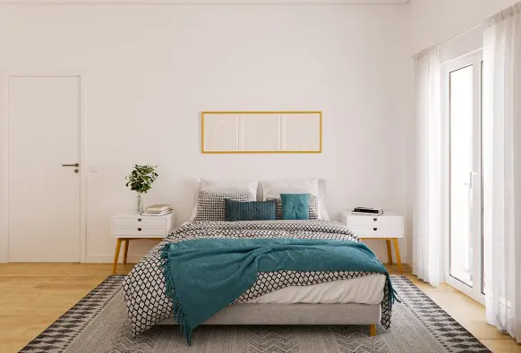Modern bedroom with a bed featuring a teal throw, patterned bedding, white nightstands, and a gold-framed wall art piece.