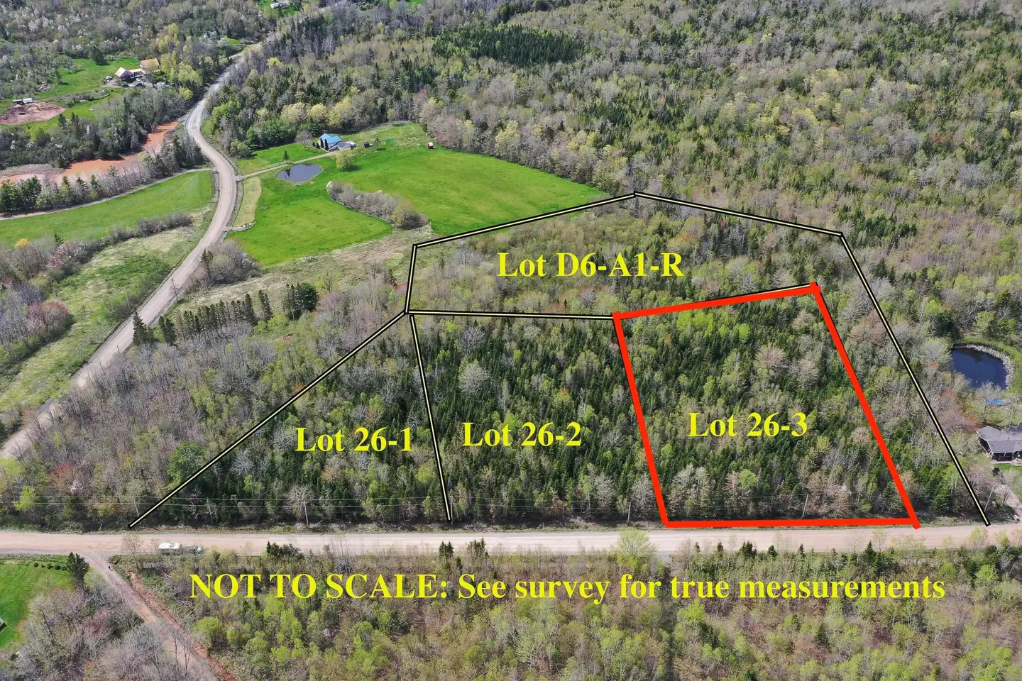 Aerial view of wooded lots, "Lot 26-3" outlined in red, with road access. Text: "NOT TO SCALE: See survey for true measurements."