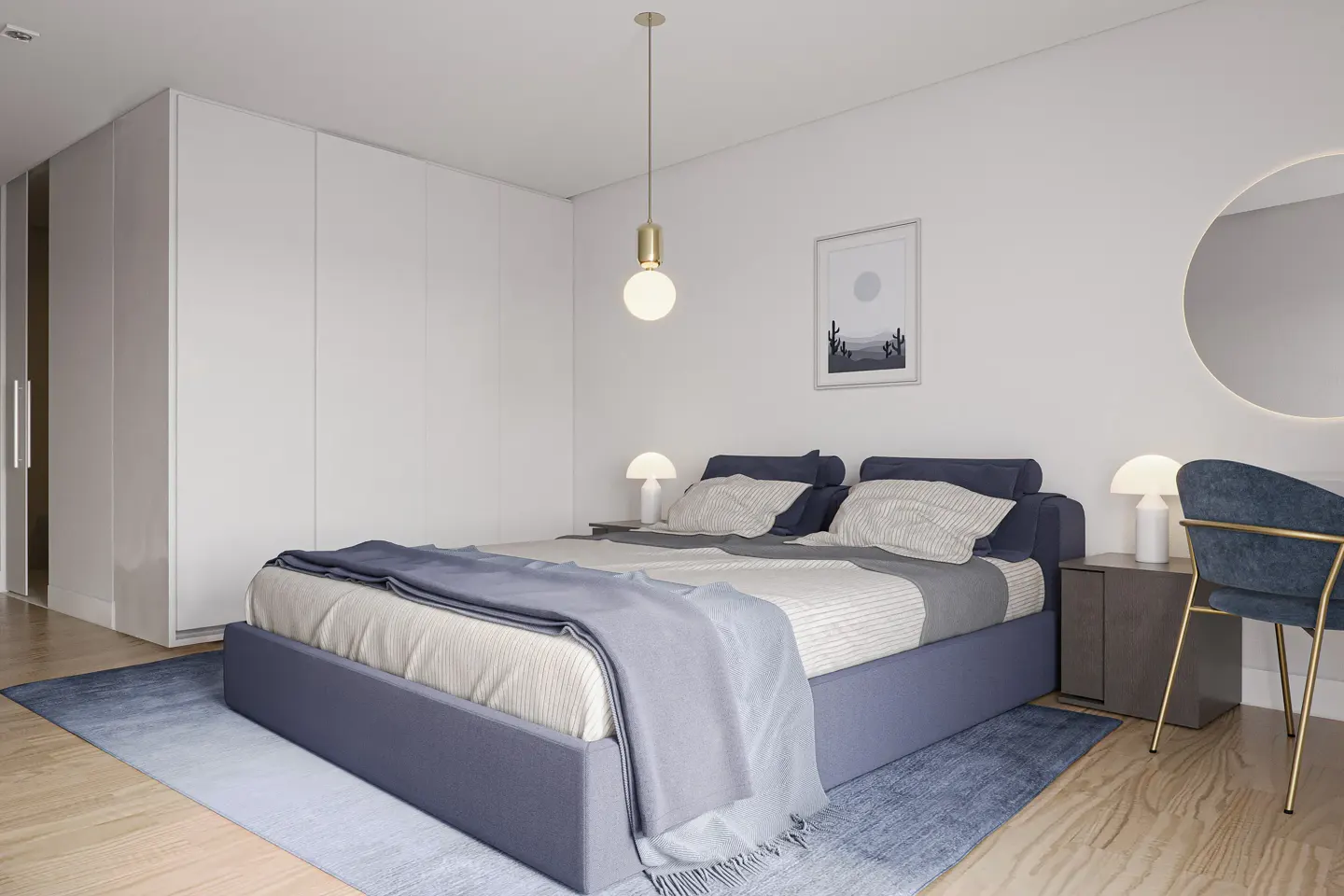 Bedroom with a blue bed, white walls, and wood floors. A blue chair sits next to a round mirror and a nightstand with a lamp.