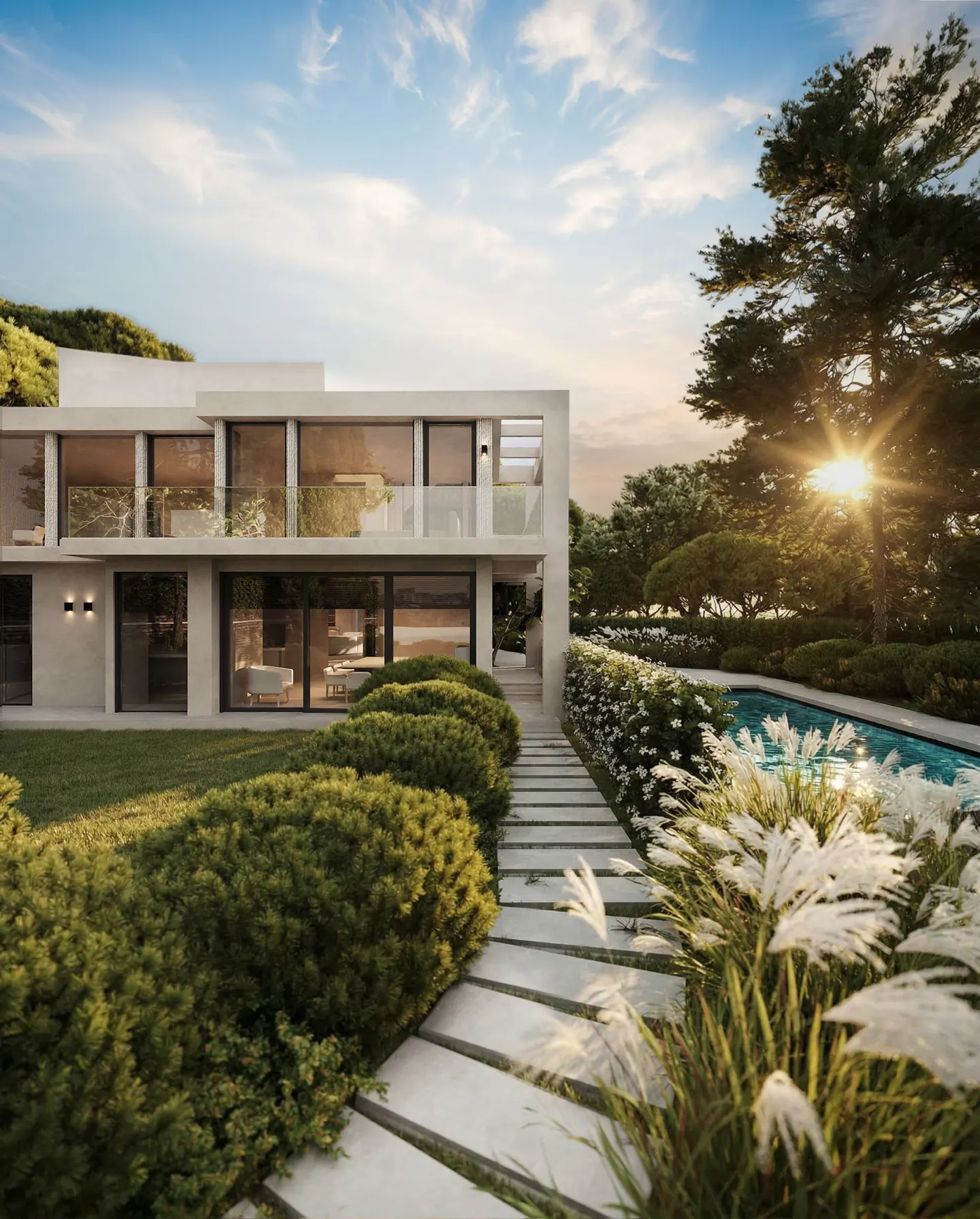 Modern two-story home with large windows, a stone walkway, and a pool surrounded by lush greenery at sunset.