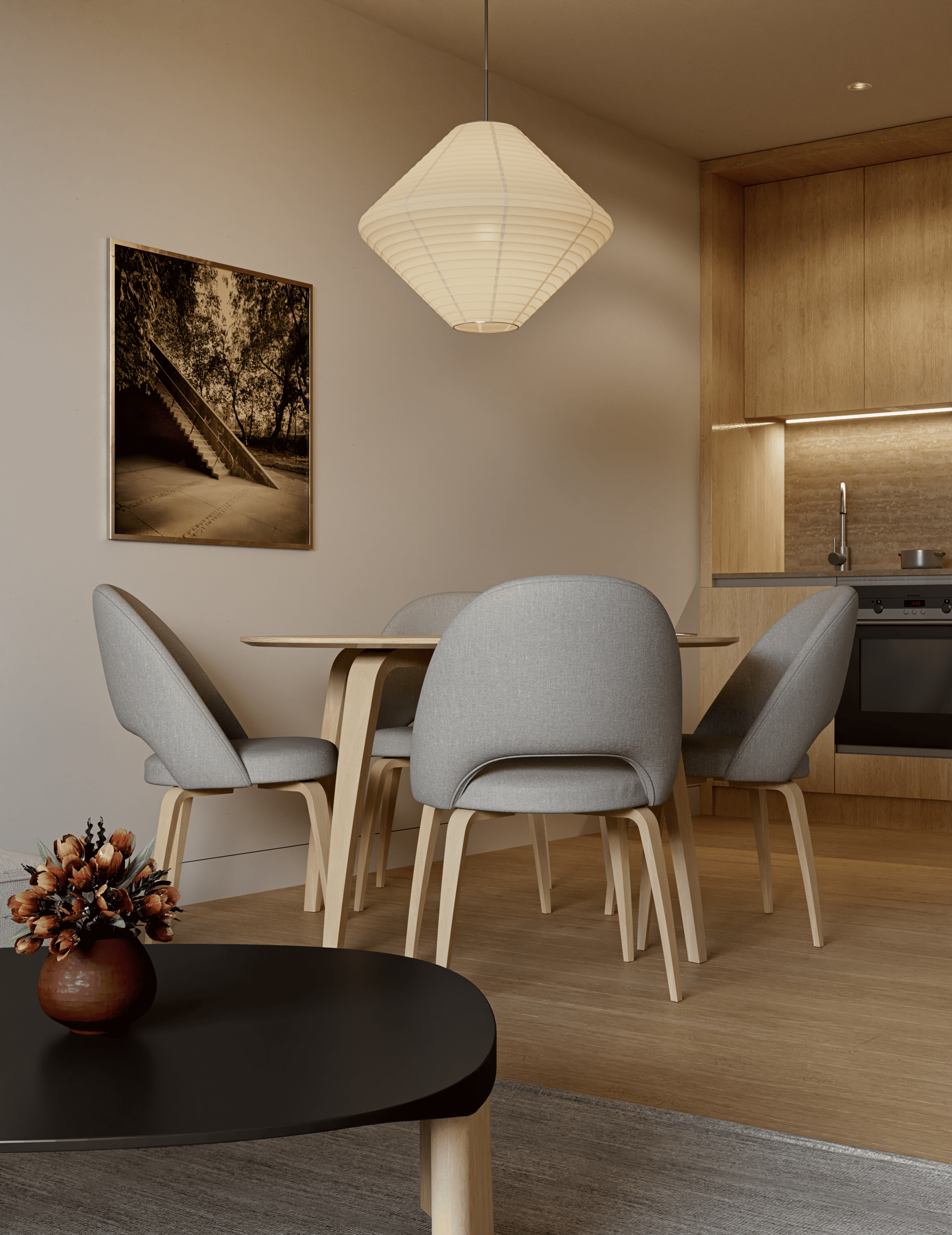 Modern dining area with light wood table, grey upholstered chairs, a paper pendant light, and a framed wall print.