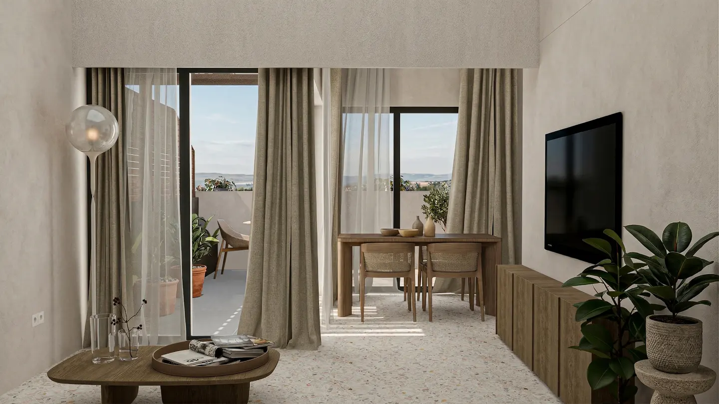 A bright living room with a dining table, TV, and balcony. Neutral tones dominate the color scheme. Plants add a touch of greenery.