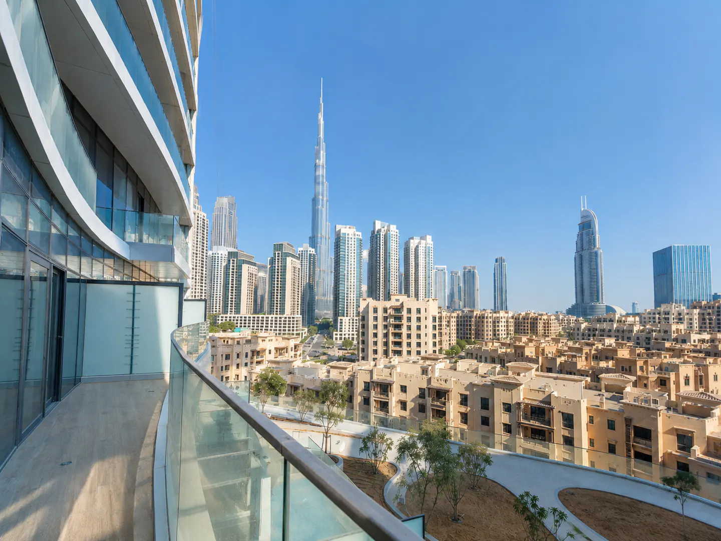 View from a balcony overlooking Dubai's skyline, including the Burj Khalifa, on a clear day.