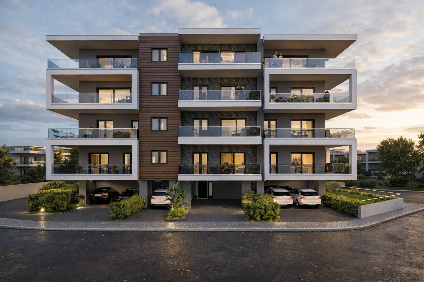 Modern four-story apartment building with balconies, parking, and landscaping at dusk.