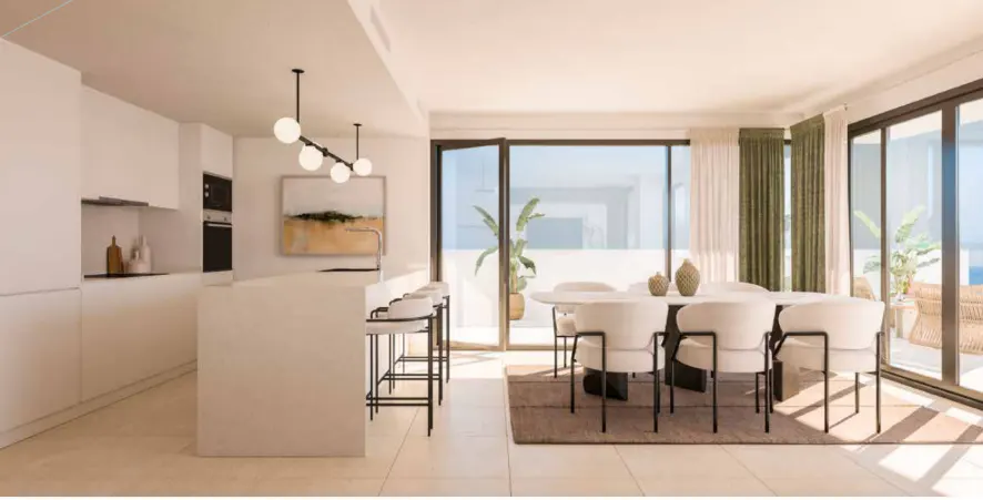 Bright, modern kitchen and dining area with white cabinets, island, and table with chairs. Sliding glass doors lead to a sunny patio.