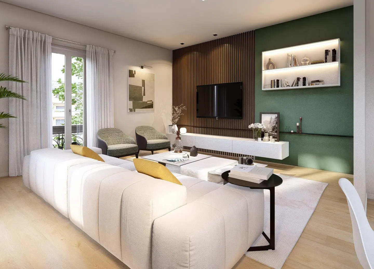 Bright living room with a large white sofa, two green chairs, and a flat-screen TV on a wood-paneled wall. A white shelf displays books and decor.
