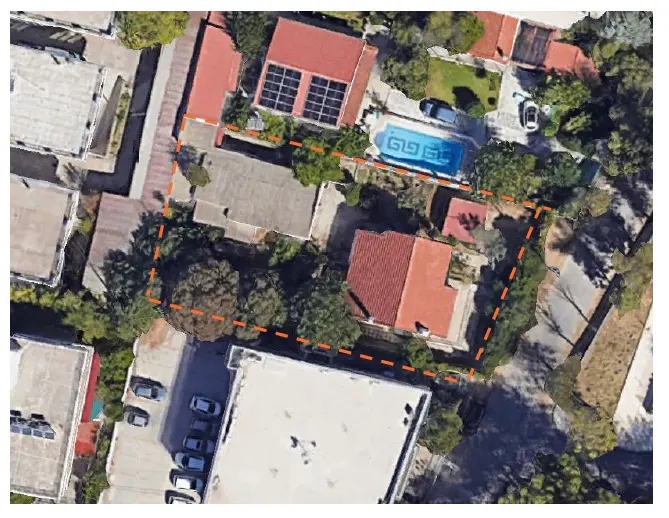 Aerial view of a property with a red-roofed house, pool, solar panels, and lush greenery, outlined in orange.