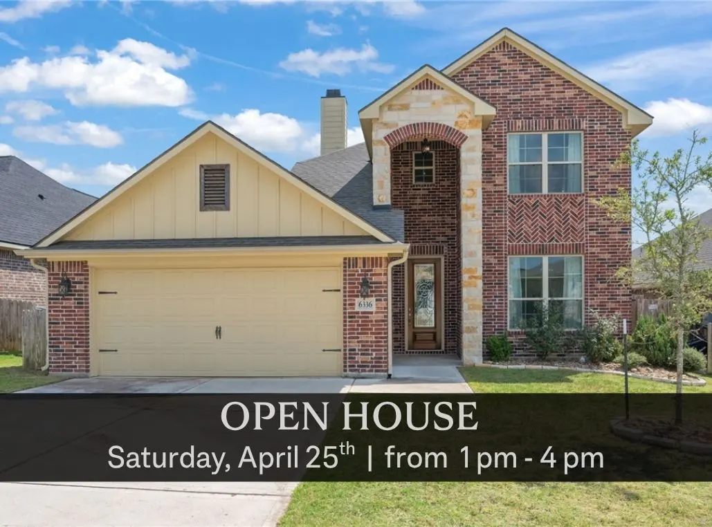 Two-story brick house with a tan garage door and an "Open House" banner in front.