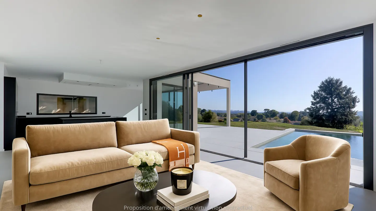 Bright living room with tan sofa, chair, and black table. Large windows overlook a pool and green landscape.