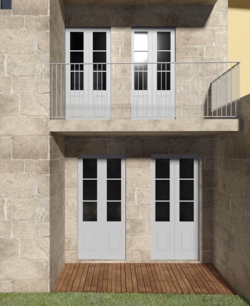 Two-story stone house exterior with white French doors, a metal balcony railing, and a wooden deck on the ground level.