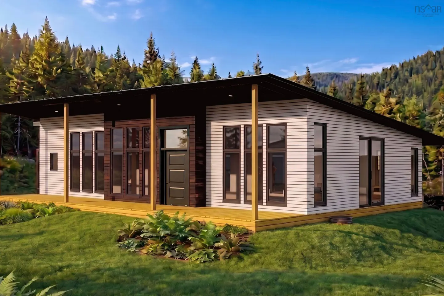 Modern, single-story home with white siding, black trim, and a flat roof. A wooden deck surrounds the house, set against a backdrop of green grass and trees.