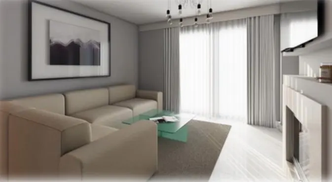 Living room with beige sofa, glass table, and gray walls. A framed art piece hangs above the sofa. Natural light streams through sheer curtains.