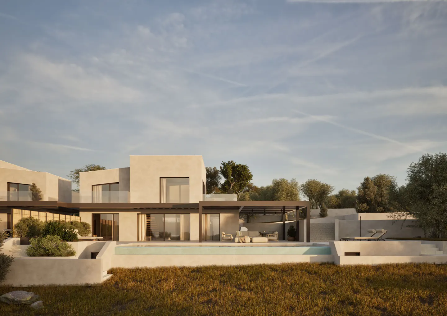 Modern beige house with a pool and pergola. Lawn in the foreground, trees and blue sky in the background.