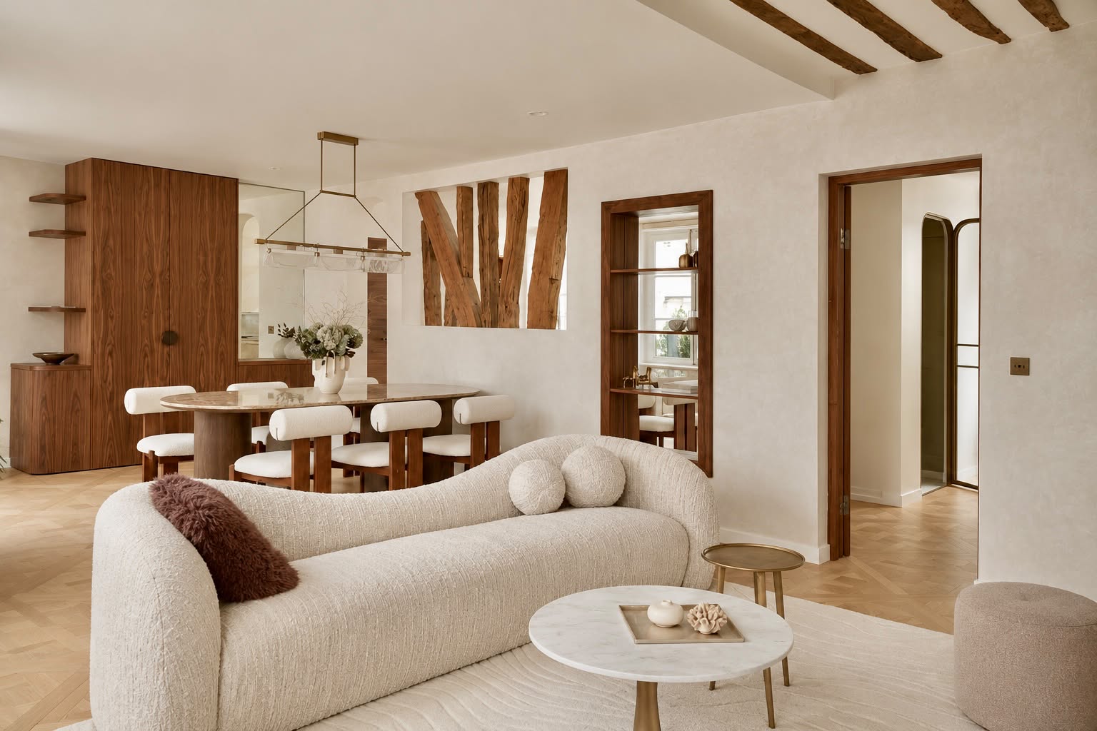 Modern living room with a cream curved sofa, marble coffee table, and a dining area featuring wood accents and white chairs. [AI-generated text]