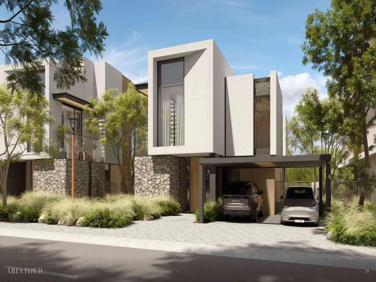 Modern two-story white villa with stone accents and a carport. Two cars are parked underneath. Trees and blue sky in the background.