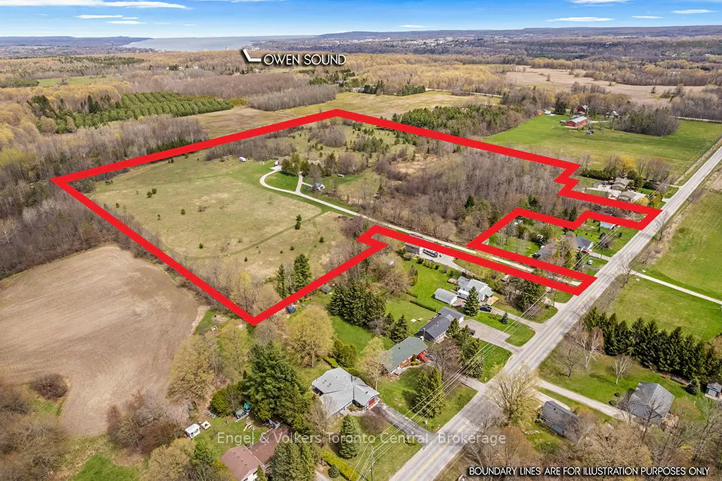 Aerial view of a large property outlined in red, near Owen Sound, with fields, trees, and houses.