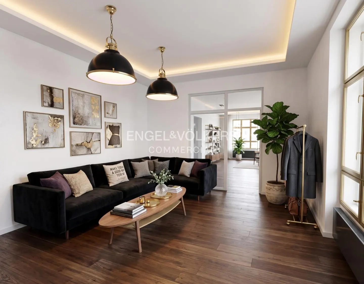 Living room with dark wood floors, black sectional sofa, and modern art on the wall. Two black pendant lights hang from the ceiling.