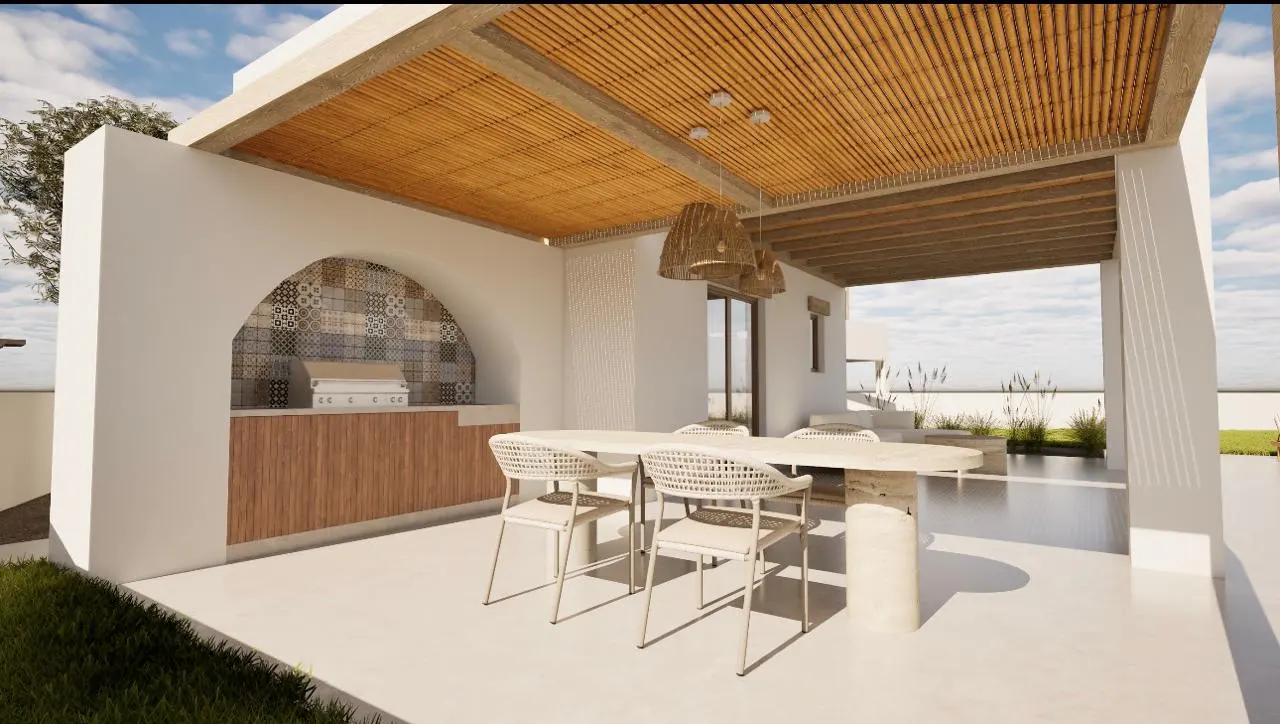 Outdoor dining area with a white table and chairs under a bamboo roof, featuring a built-in grill and tiled backsplash.