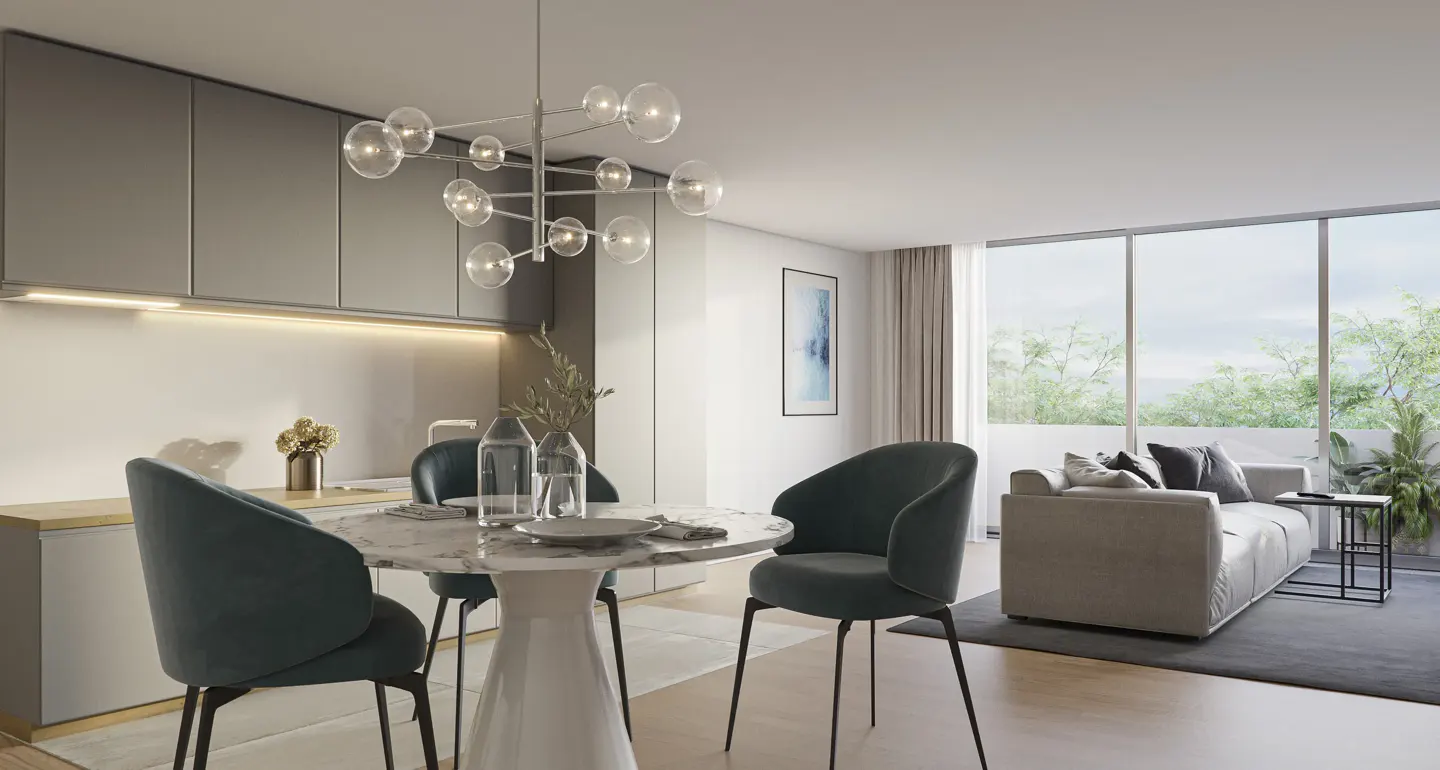 Open-concept living space with a round marble table, teal chairs, and a modern chandelier. A gray sofa sits near a large window.