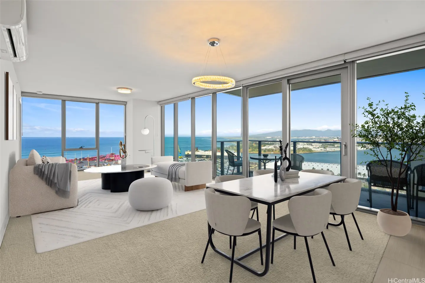 Bright, modern condo interior with ocean views. White furniture, marble table, and floor-to-ceiling windows. Balcony with potted plant.