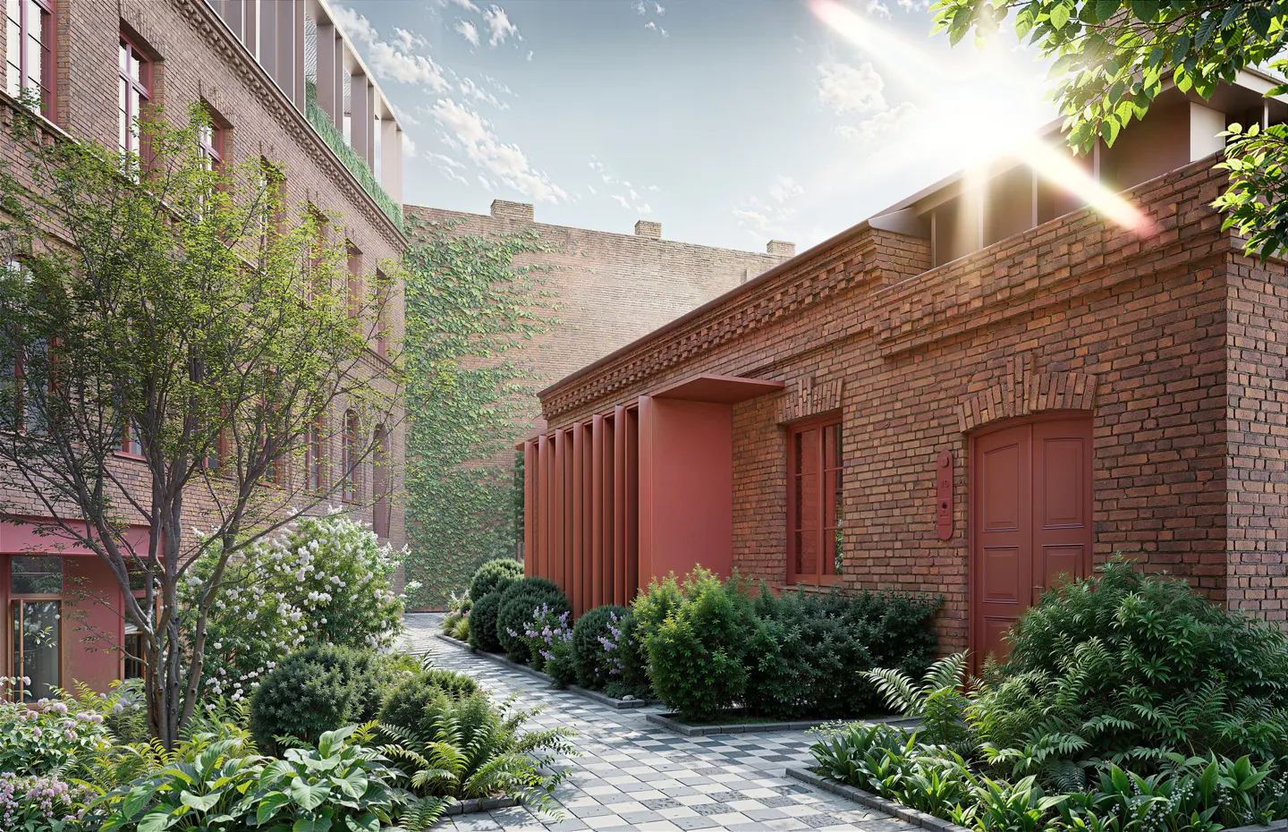 Exterior view of a brick building with a garden and a stone path on a sunny day.