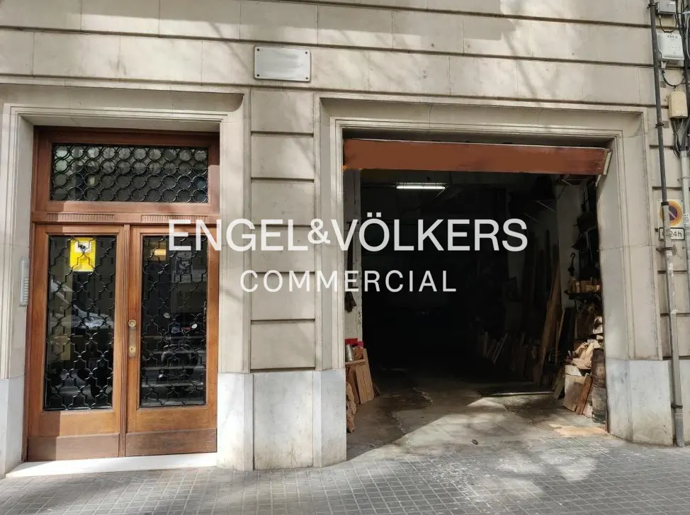 Exterior of a commercial building with a brown door and an open garage door. "Engel & Völkers Commercial" is superimposed on the image.