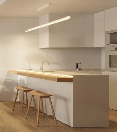 Modern minimalist kitchen with white cabinets, a wooden breakfast bar, two wooden stools, and a sleek linear pendant light.