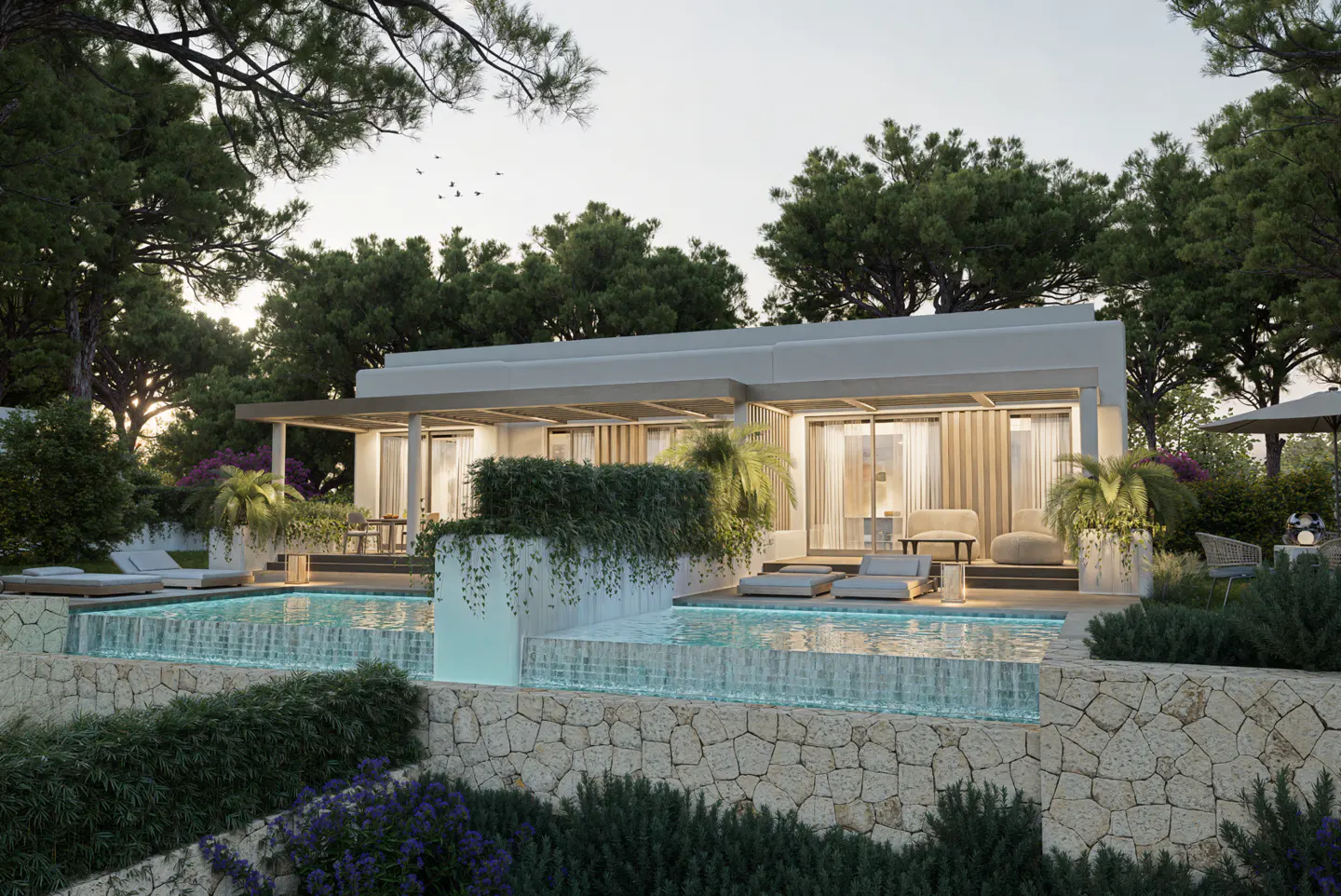 Luxury villa with a pool. Stone wall, lush greenery, and trees surround the modern, light-colored building. Lounge chairs sit by the pool.