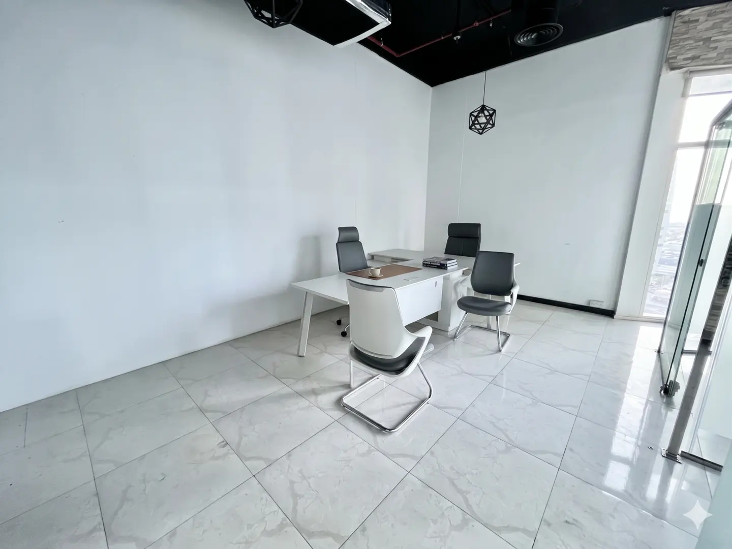 Modern office with white walls, marble tile floors, a white desk, and three ergonomic chairs under a black ceiling.