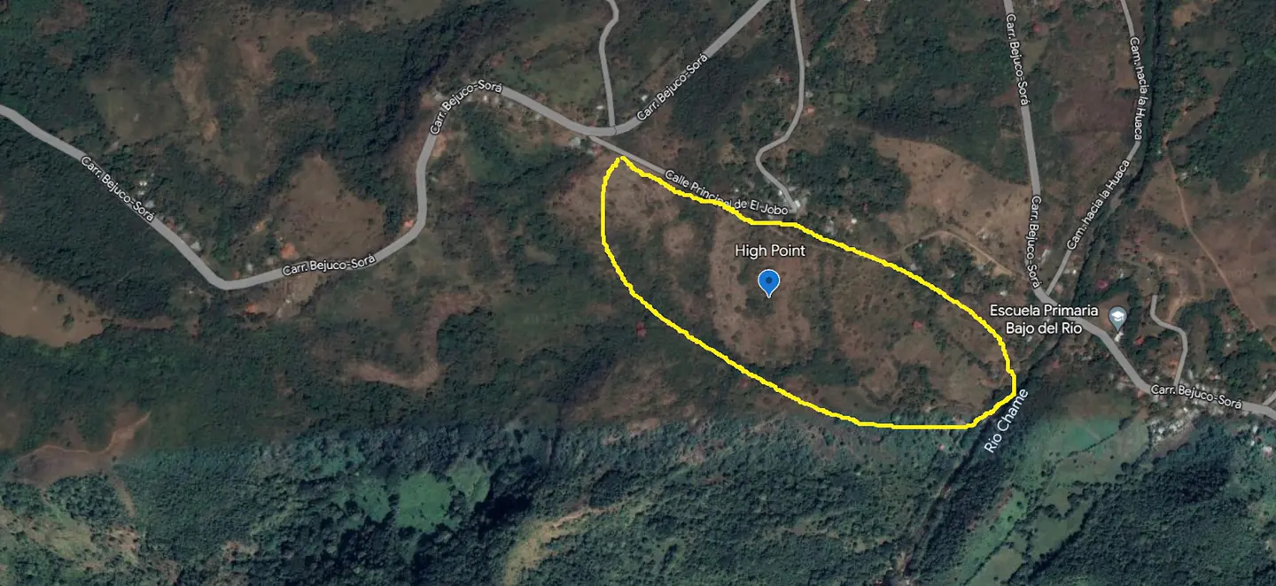 Aerial view of land outlined in yellow, labeled "High Point," near roads, a river, and a school in a rural, hilly area.