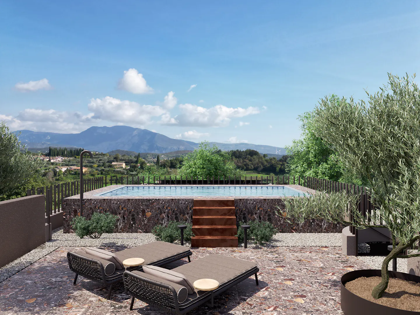 Outdoor pool area with two lounge chairs, stone pool wall, wooden steps, and mountain view under a blue sky.