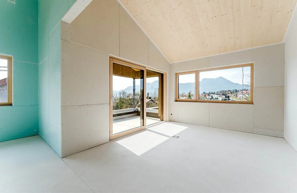 Unfinished room with light wood ceiling, drywall walls, and sliding glass doors to a balcony with mountain views.