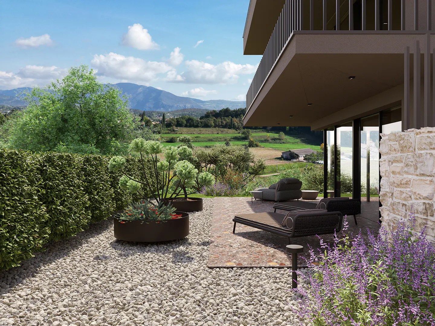 Modern home patio with lounge chairs, potted plants, and purple flowers. A green field and mountains are in the background.