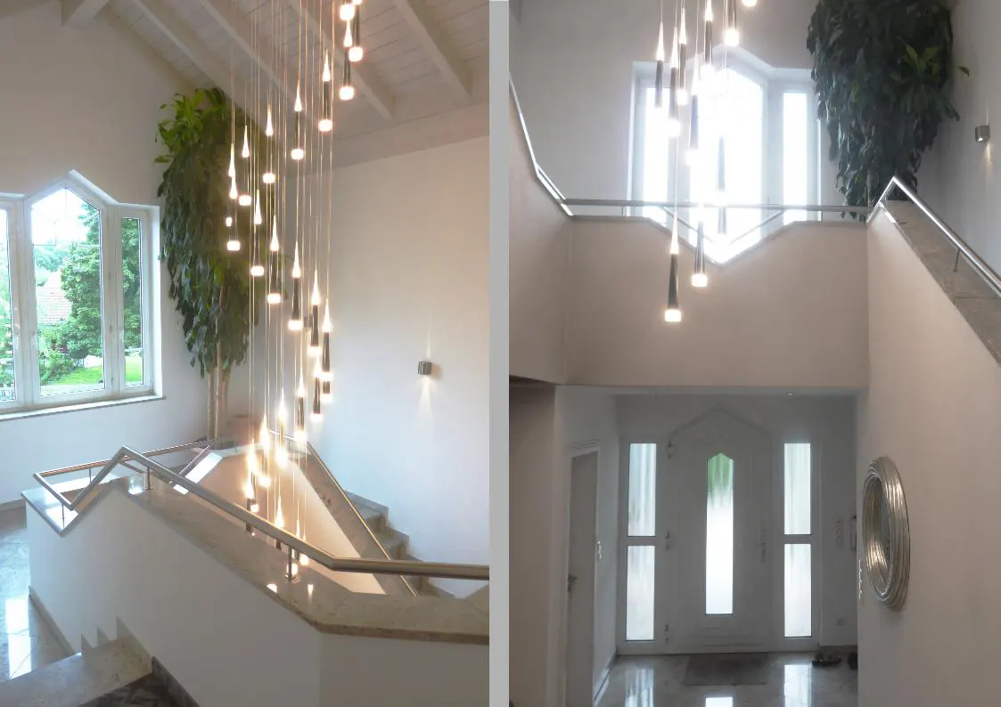 Two-panel view of a bright, modern foyer with a staircase, chandelier, and large windows. The walls are white, and the floors are shiny.