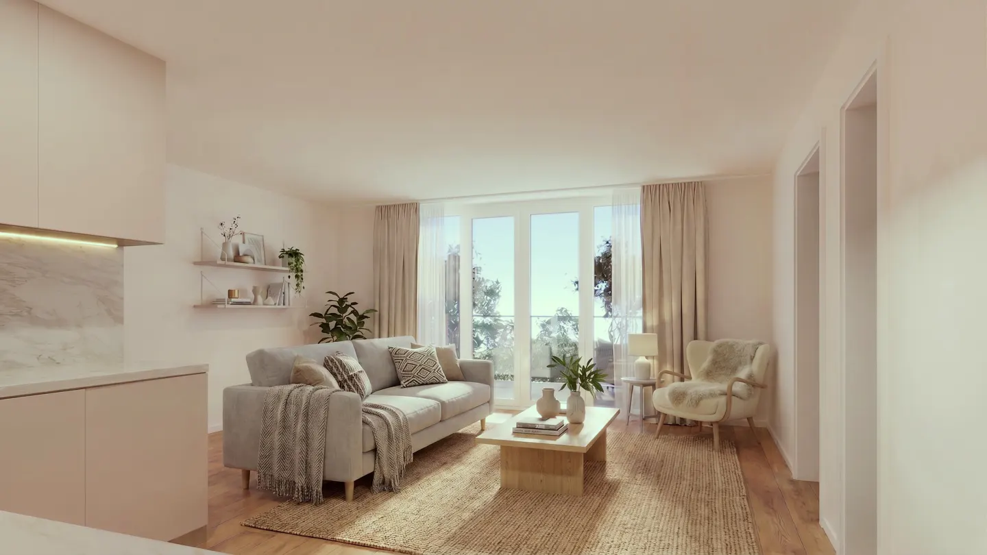 Living room with a gray sofa, beige rug, and a view of trees through a large window.