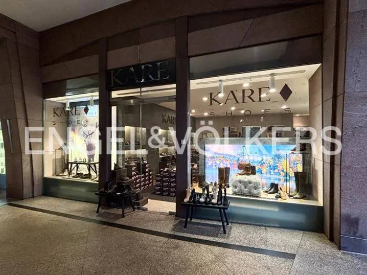 Exterior view of Kare Shoes store with shoes displayed in the window and on tables outside.