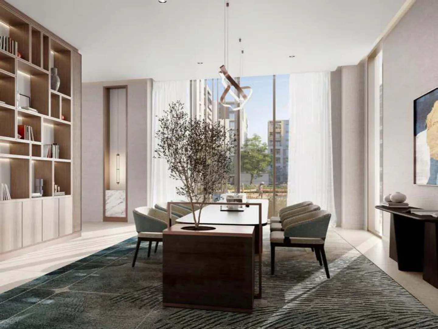 Bright dining room with a long table, six chairs, and a tree in a planter. A bookshelf is on the left, and a window with white curtains is in the background.