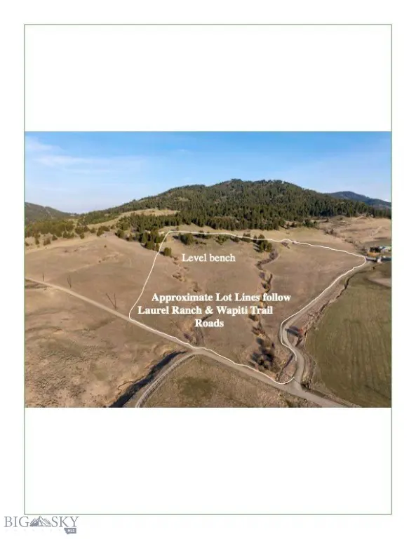 Aerial view of a brown field with trees and a blue sky. Lot lines follow Laurel Ranch and Wapiti Trail Roads.